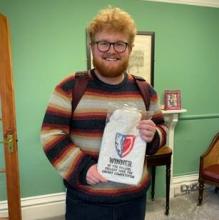 Benjamin holding his hot water bottle.